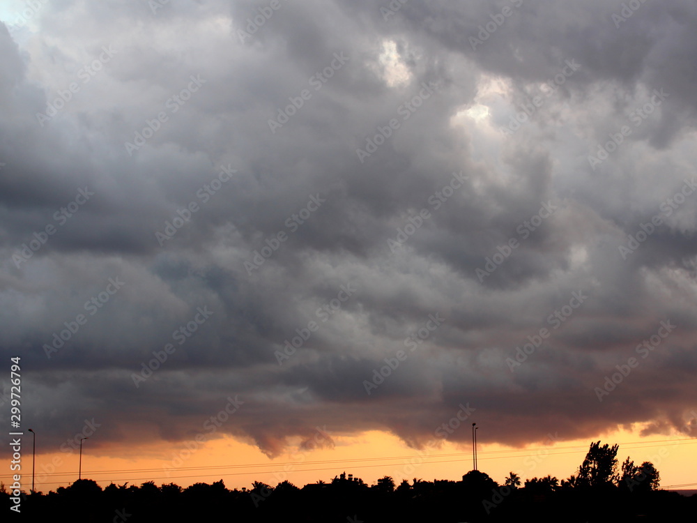 Rain clouds and sunset in rainy weather