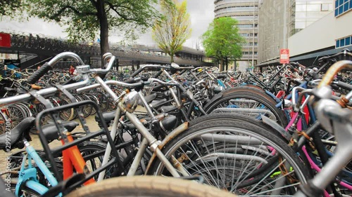 Close-up, a lot of bicycles in a parking lot near the central station of Amsterdam. Environmental conservation concept.