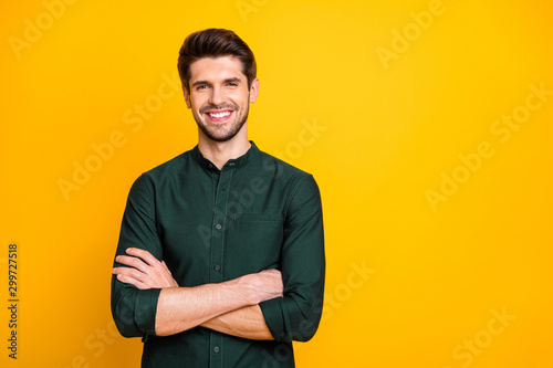 Portrait of confident cool entrepreneur guy cross hands look feel positive cheerful emotions real professional expert wear casual style clothing isolated over yellow color background
