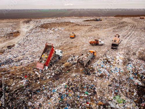 Garbage trucks unload garbage to a landfill. Ecology concept