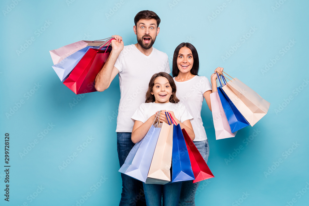 50 off. Real bargain concept. Portrait of excited three people mom dad schoolkid shop center hold bags scream wow omg wear white t-shirt denim jeans isolated over blue color background 50 off. Real bargain concept. Portrait of excited three people mom dad schoolkid shop center hold bags scream wow omg wear white t-shirt denim jeans isolated over blue color background