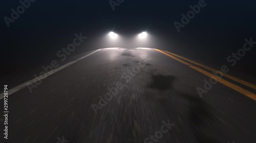 Car with headlights on follows camera tracking along country night road. Car driving down the country road with headlights turned on, seamless loop. Pursuit, chase and follow concept. photo