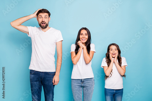 Portrait of impressed three brown hair people hear information scream wow omg wear white t-shirt denim jeans good look isolated over blue color background