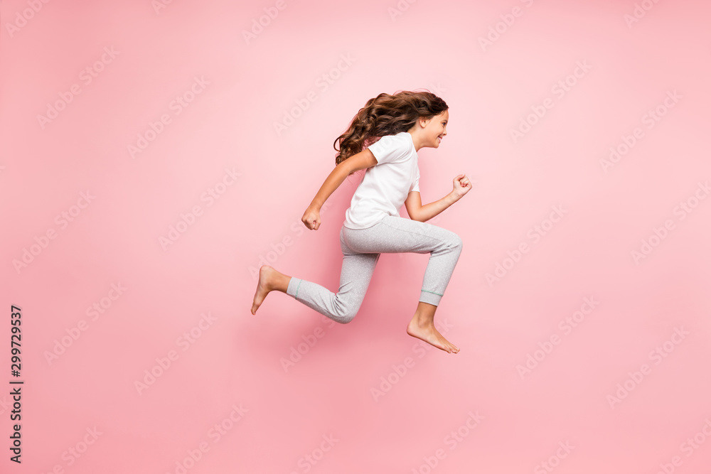 Full length body size side profile photo of cheerful barefoot positive running urgent hurrying preteen wearing t-shirt isolated over pastel color background