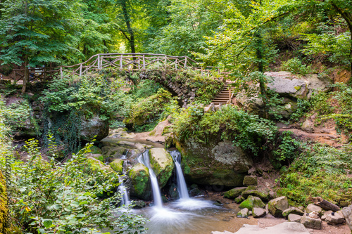 The Schiessent  mpel in M  llerthal   Luxembourg - waterfall  romantic bridge and nature atmosphere