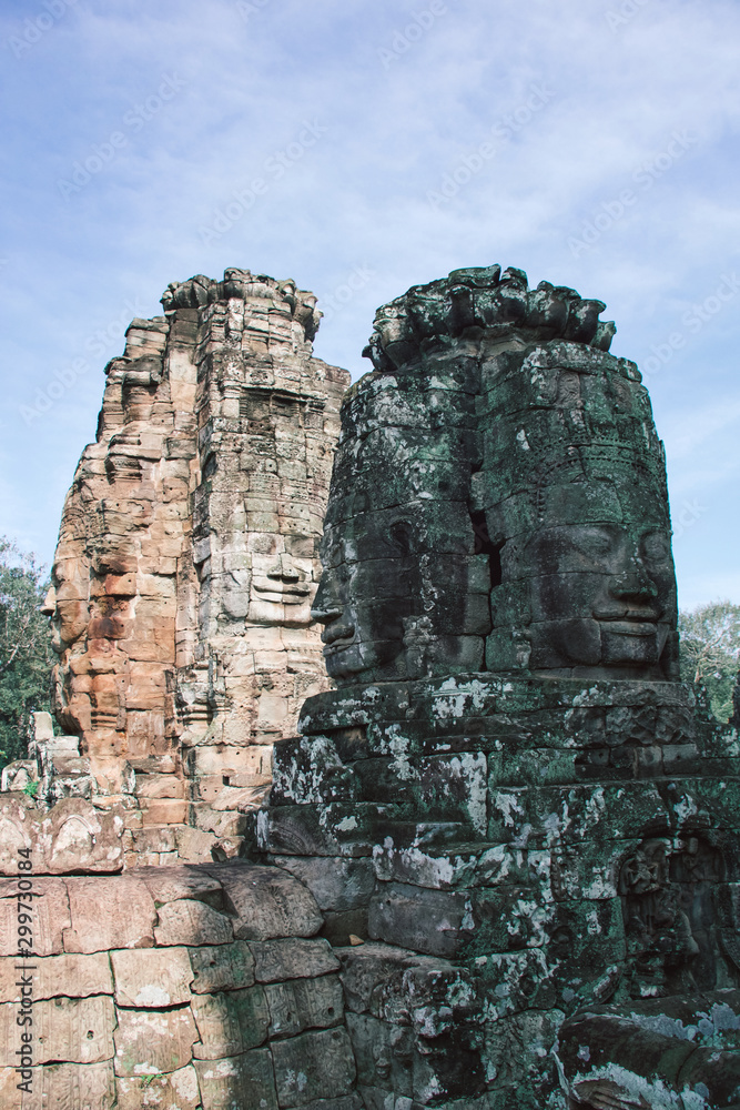 large buddha faces carved on towers of angkor thom temple