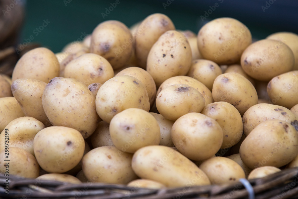 Raw potatoes in baskets on the market close up shot Raw potatoes in baskets on the market close up shot