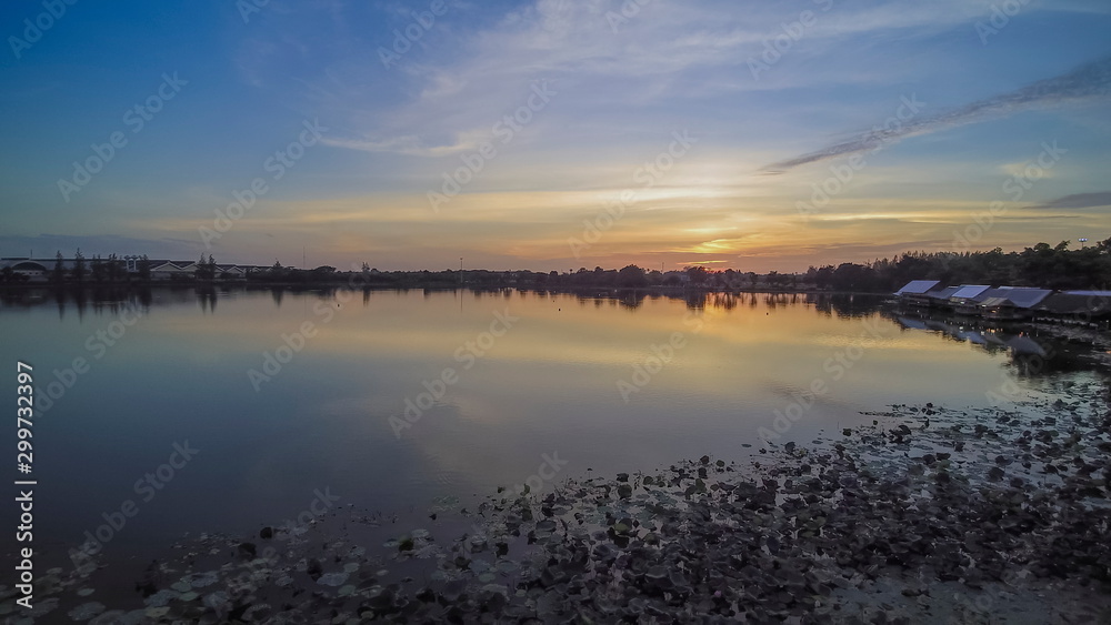 Aerial view evening above reservoir with red sun light and cloudy sky background, sunset at Krajub reservoir, Nong Kob, Ban Pong, Ratchaburi, Thailand. Aerial view evening above reservoir with red sun light and cloudy sky background, sunset at Krajub reservoir, Nong Kob, Ban Pong, Ratchaburi, Thailand.