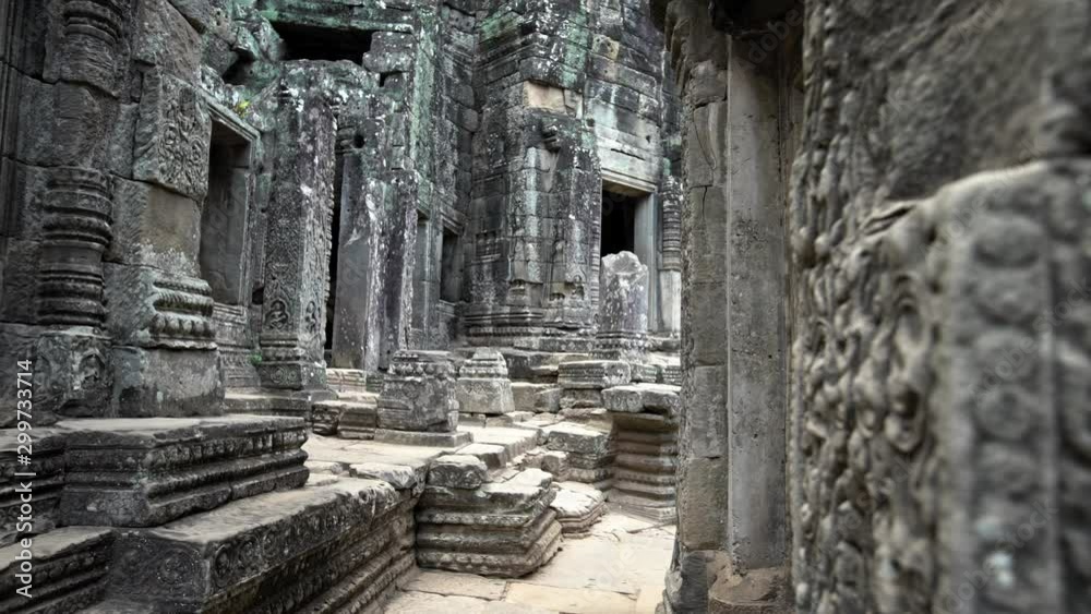 4K, View of ancient stone wall at Bayon temple in Angkor Thom. Face towers depicting Bodhisattva Avalokiteshvara. Architecture statues in Cambodia. Heritage of Khmer Empire at Siem Reap -Dan 4K, View of ancient stone wall at Bayon temple in Angkor Thom. Face towers depicting Bodhisattva Avalokiteshvara. Architecture statues in Cambodia. Heritage of Khmer Empire at Siem Reap -Dan