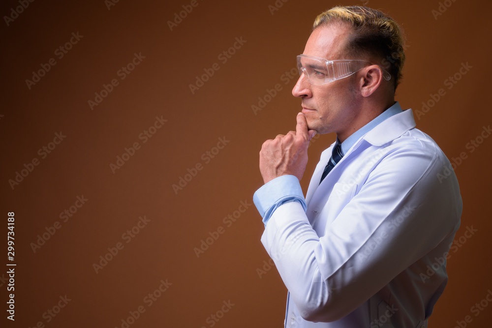 Profile view of man doctor wearing protective glasses