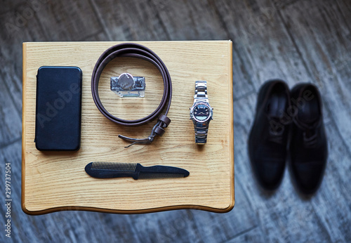 different accessories of a businessman for creating a style of a people lie on a wooden background