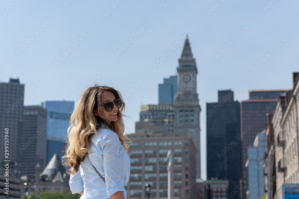 Blonde woman in blue shirt posing in Boston