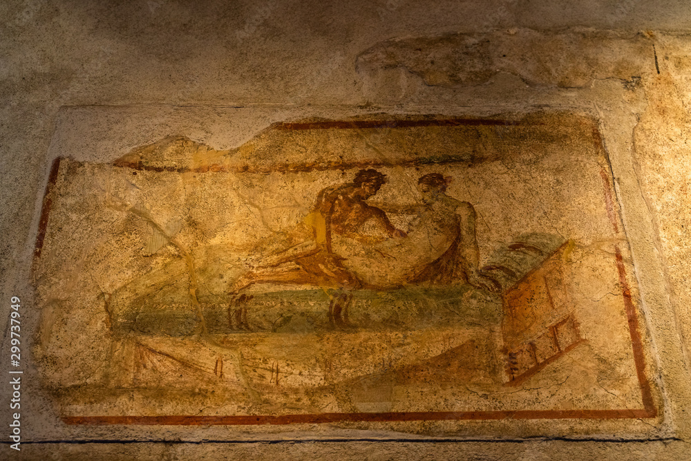 Fototapeta premium Sexual scene from a wall painting at the Lupanare, the most famous brothel in Roman city of Pompeii, Italy