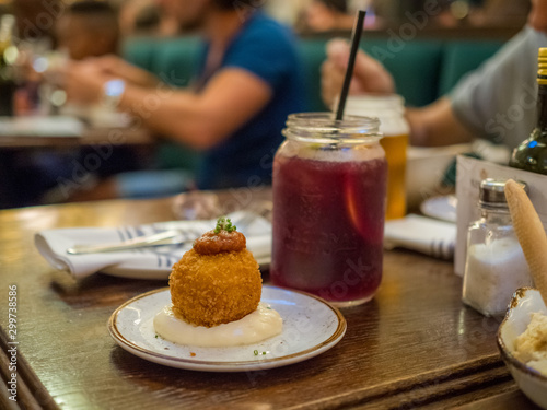 Spanish tapa called bomba served at a restaurant in Barcelona, Spain