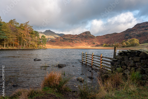 Morning light at Blea Tarn in the English Lake District with views of the Langdale Pikes, and Side Pike during autumn. photo