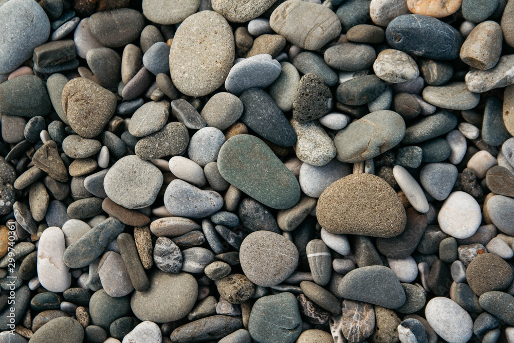 Gravel pattern of colored stones. Abstract nature pebbles background. Stone background. Sea peblles beach. Top view. Gravel pattern of colored stones. Abstract nature pebbles background. Stone background. Sea peblles beach. Top view.