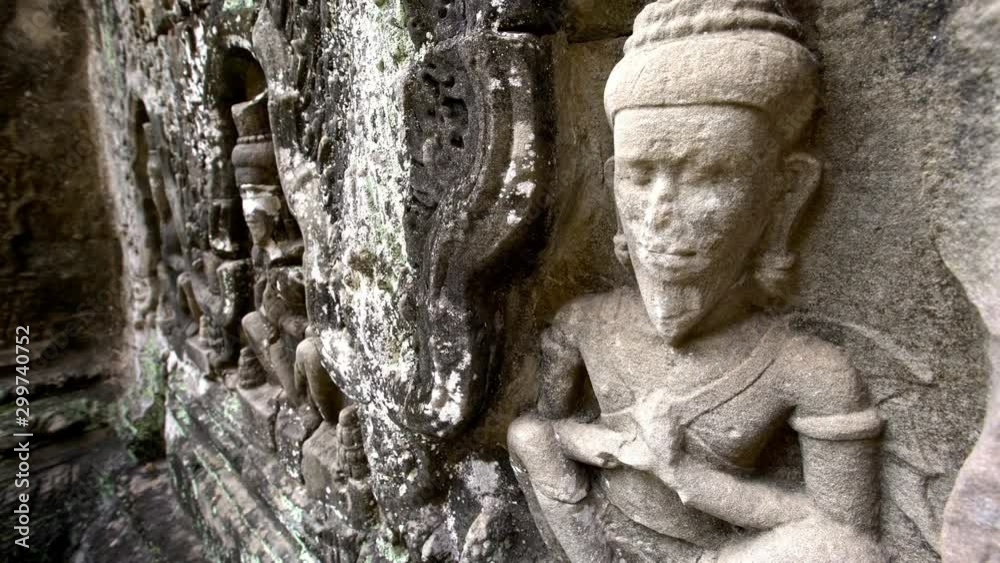4K, Carved structures in Preah Khan. Ancient carvings adorn the temple walls of world-heritage site Angkor Thom. Bas reliefs and stone sculpture on the building of Khmer empire. Ruins of Cambodia.-Dan 4K, Carved structures in Preah Khan. Ancient carvings adorn the temple walls of world-heritage site Angkor Thom. Bas reliefs and stone sculpture on the building of Khmer empire. Ruins of Cambodia.-Dan