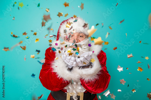 Santa Claus blowing confetti