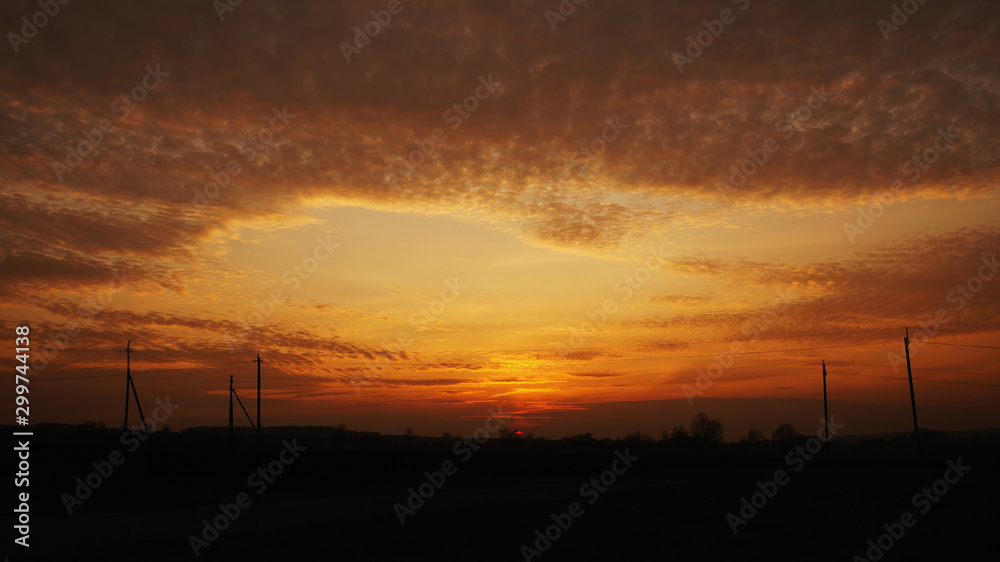 sunset sky on the background of a darkening country road