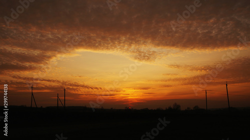 sunset sky on the background of a darkening country road