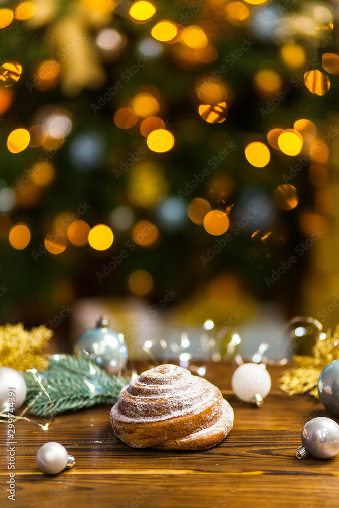 Fototapeta premium Homemade traditional winter festive Bun on wooden background.