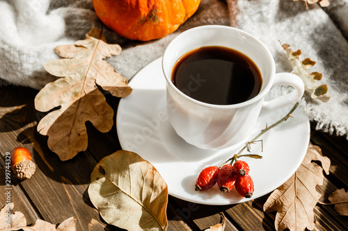 beautiful autumn composition with coffee. autumn leaves and pumpkins on a rustic tree background. the concept of the fall season