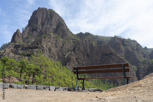 Lonely wooden bench in the mountain in relax and peaceful view point. Place to rest and calm spot with great peak and empty sea.