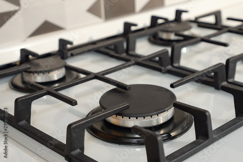 close up of modern stainless steel silver gas stove with black elements
