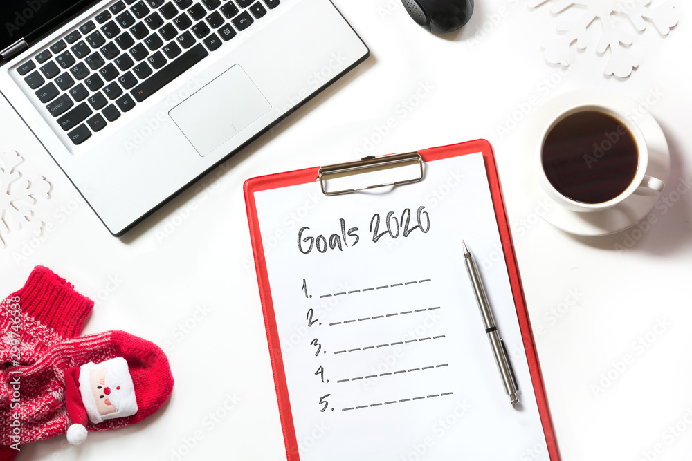 2020 New Year goals, planning, dreams and wishes. Office workplace with laptop on white. Top view with copy space. 2020 New Year goals, planning, dreams and wishes. Office workplace with laptop on white. Top view with copy space.