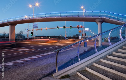 Modern Dutch architecture. Glass pedestrian bridge Barendrecht. Stairs. Evening. Twilight photo