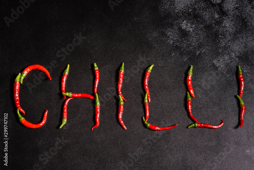 Bright red chilli pepper on a grey concrete background. Spicy food, ingredients