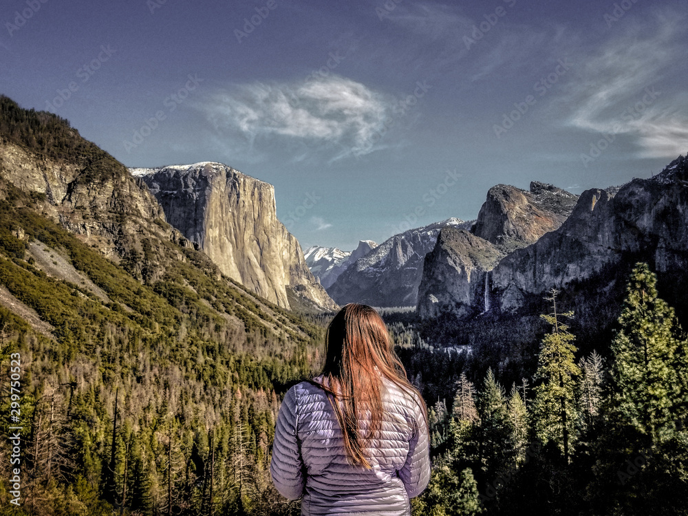 Young woman looking into iconic Tunnel View in Yosemite Valley.