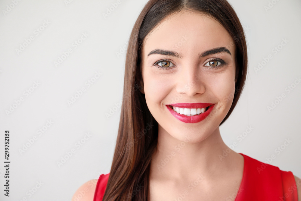 Portrait of happy young woman on light background Portrait of happy young woman on light background