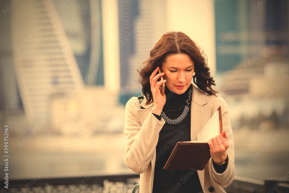 Fototapeta premium beautiful middle-aged woman using a smartphone