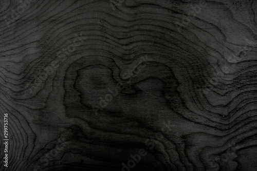 The texture is tinted in black plywood. Wooden background. Woodworking.
