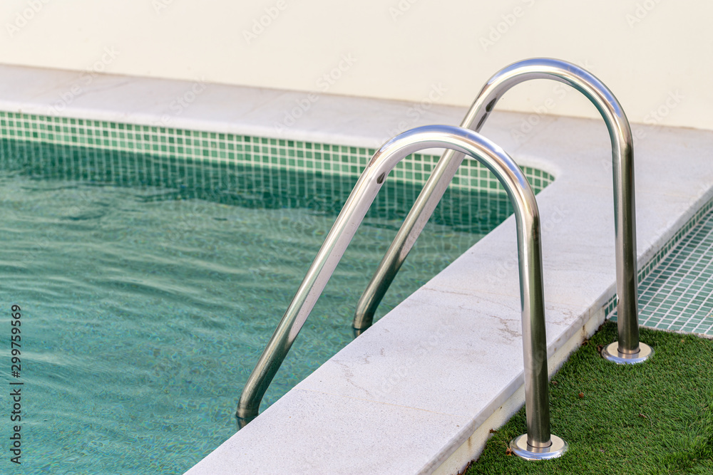 Inox railings in the pool on the grass. Inox railings in the pool on the grass.