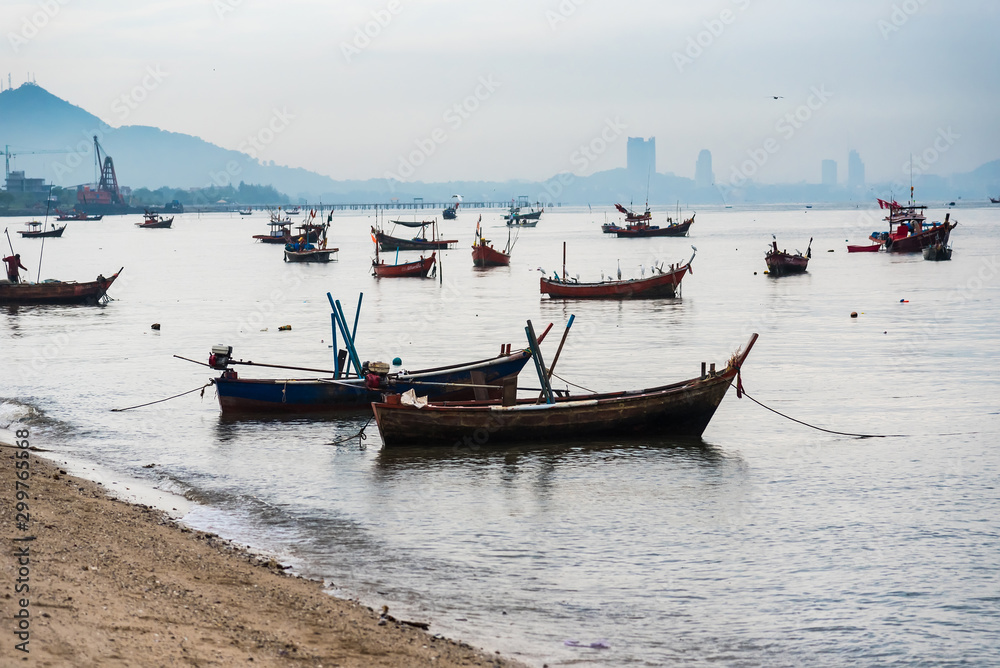 Chon Burii, Thailand - October, 05, 2019 : Fishing boats floating in the sea over cloudy sky,Chon Burii, Thailand