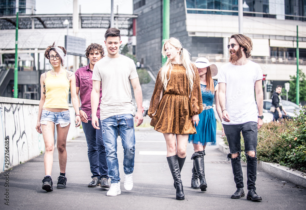 Group of teenagers walking in the city center Group of teenagers walking in the city center