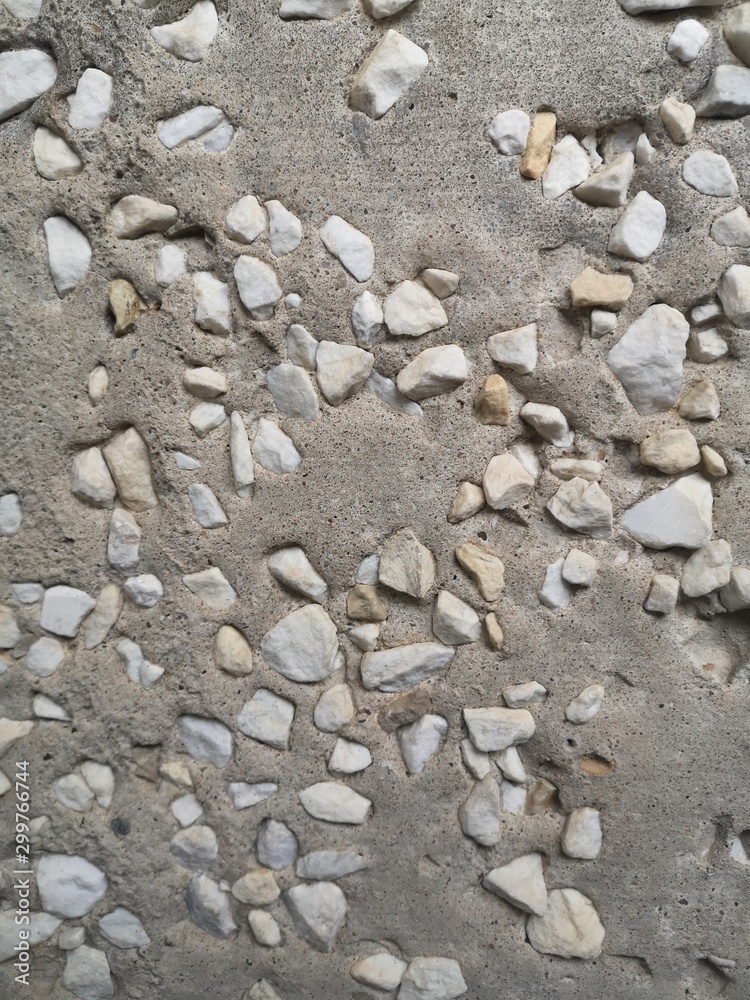 A lot of small white pebbles in porous gray concrete, texture A lot of small white pebbles in porous gray concrete, texture