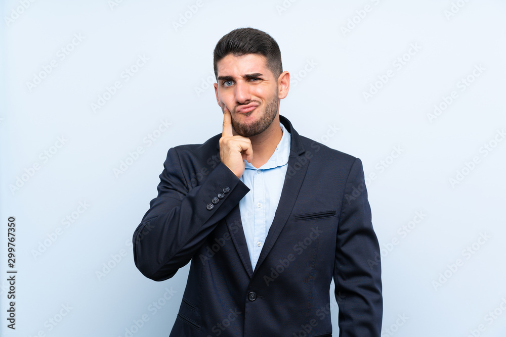 Handsome man over isolated blue background Looking front Handsome man over isolated blue background Looking front