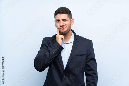 Handsome man over isolated blue background Looking front
