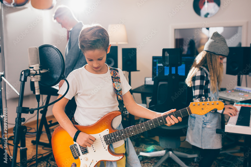 Fototapeta premium kids rock band playing in music studio