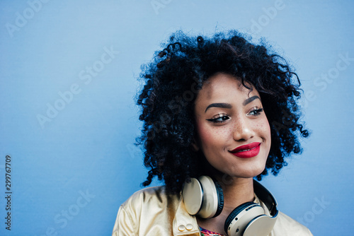 Beautiful latin woman with curly hair, portrait set in the city photo