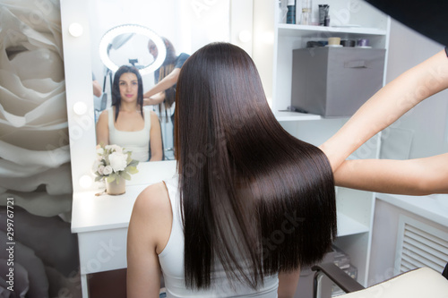 Saturated healthy shiny hair after keratin recovery. The concept of recovery structure. photo