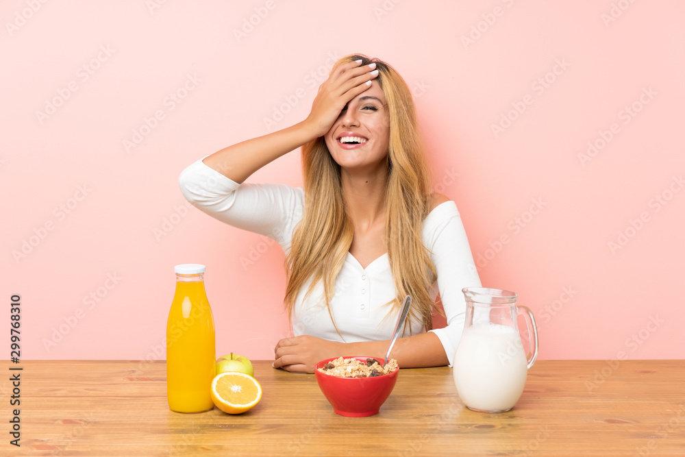 Young blonde woman having breakfast milk laughing Young blonde woman having breakfast milk laughing