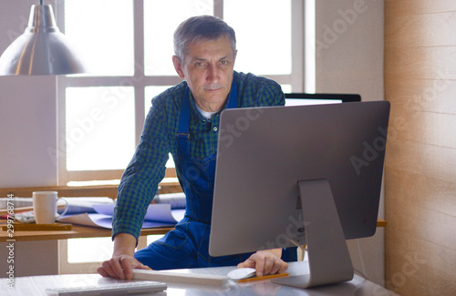 Engineer carpenter working on laptop and sketching project