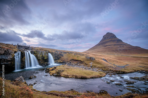 Incredible Nature landscape of Iceland. Fantastic picturesque sunset over Majestic Kirkjufell  Church mountain  and waterfalls. Kirkjufell mountain  Iceland. Famous travel locations..