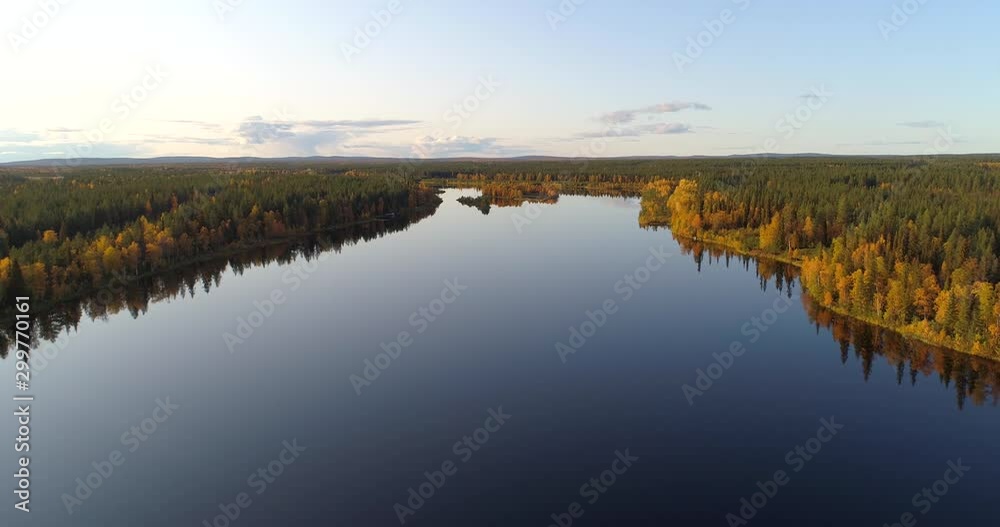 Autumn in Lapland, Aerial, rising, drone shot, towards Peurasaari isle, at lake Almansuvanto, surrounded by foliage forest and ruska nature, at golden hour, on a fall evening, in Sodankyla, Finland Autumn in Lapland, Aerial, rising, drone shot, towards Peurasaari isle, at lake Almansuvanto, surrounded by foliage forest and ruska nature, at golden hour, on a fall evening, in Sodankyla, Finland