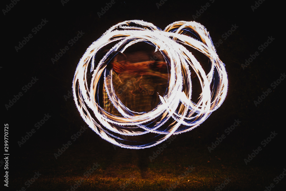 Fire spinner making different figures with fire. Slow motion image Fire spinner making different figures with fire. Slow motion image