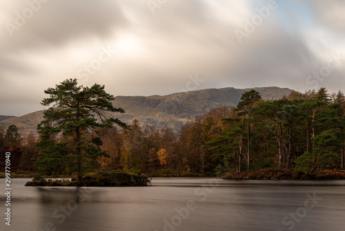 Morning light at Tarn Hows in the English Lake District with views of Yewdale Crag, and Holme Fell during autumn. photo